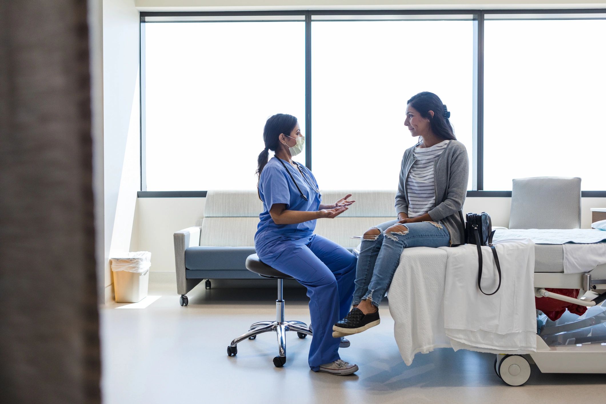 Female patient speaking with a doctor in a medical office