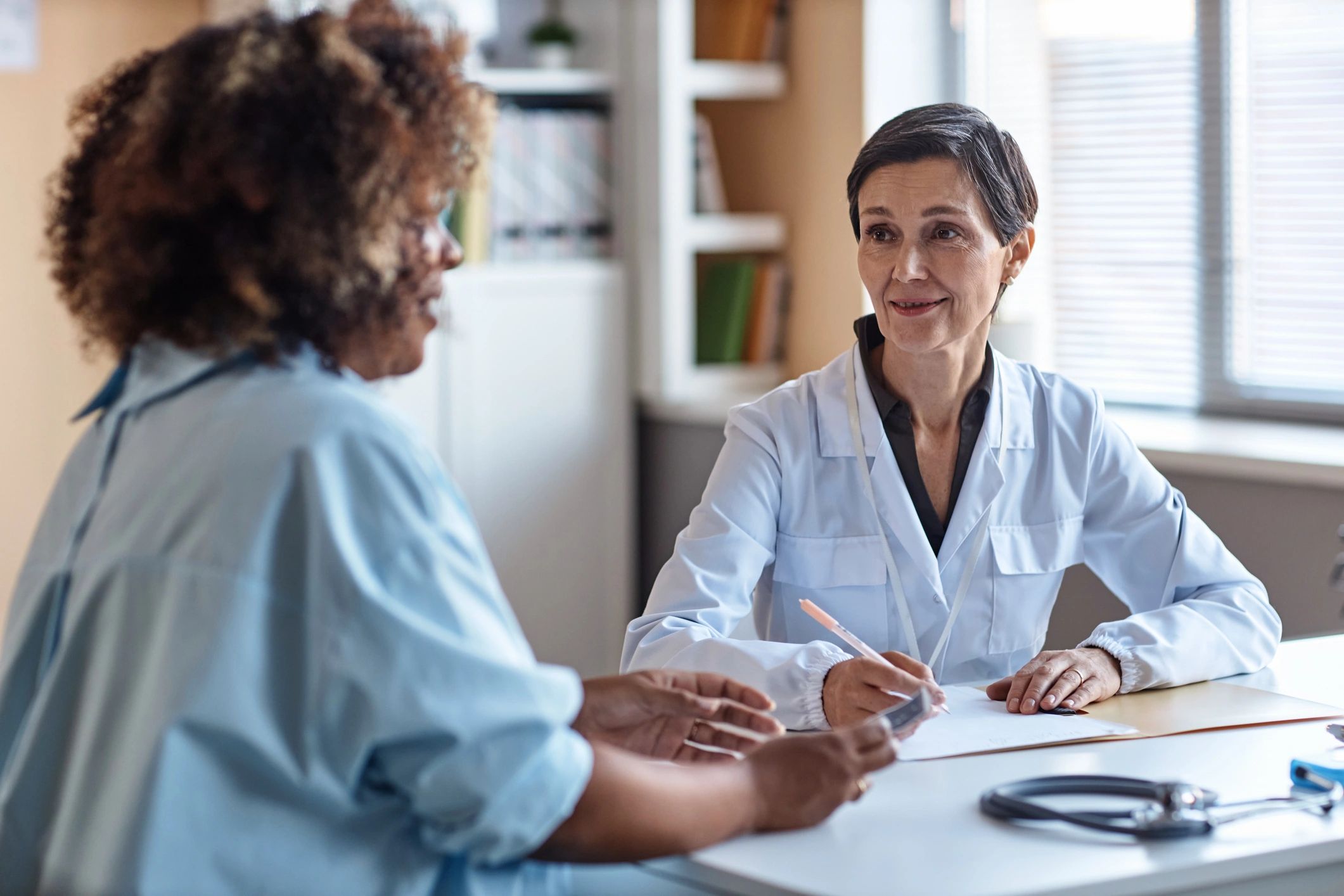 Physician meeting with a patient during a consultation